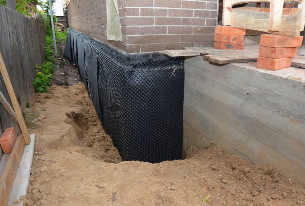 SJ Waterproofing Pros technician performing targeted Exterior Waterproofing assessment in Norman, IN